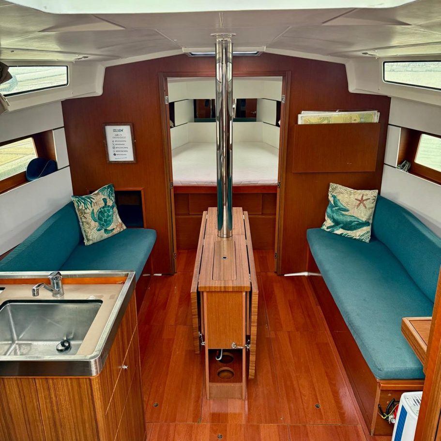 Marina Deep Cleaning – After Photo | Professional Results/ Sink Interior of a modern boat featuring a sink, seating areas, and wooden finishes.