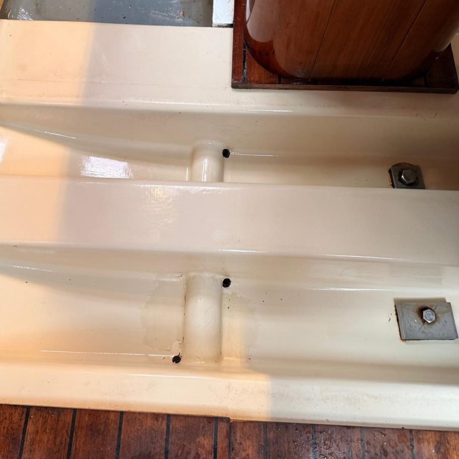 Commercial Cleaning – Industrial | After Photo | Clean Cream-coloured boat interior with two parallel channels and wooden accents.